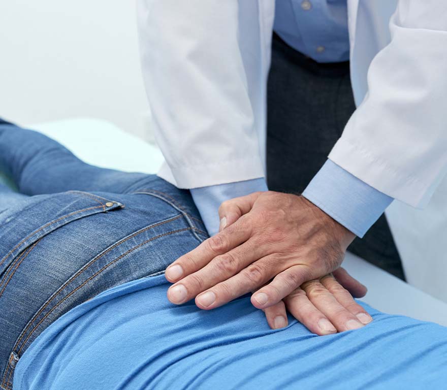 Patient receiving chiropractor adjustment for low back pain
